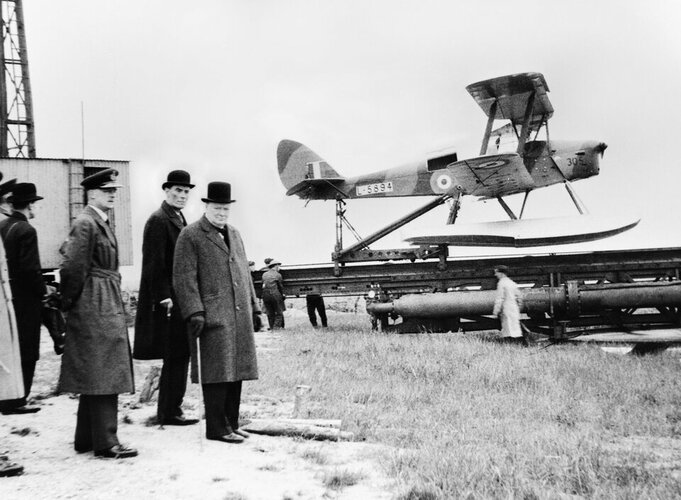 Winston_Churchill_and_the_Secretary_of_State_for_War_waiting_to_see_the_launch_of_a_de_Havilla...jpg
