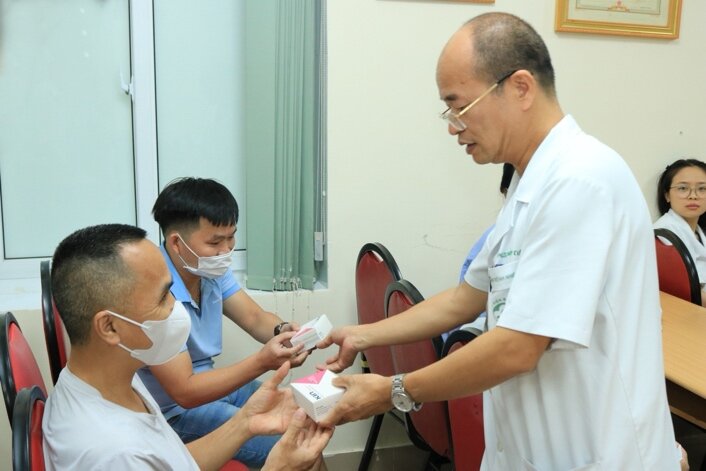 A doctor giving a patient a medicineDescription automatically generated A doctor giving a patient a medicineDescription automatically generated